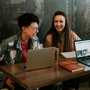 Two people at a meeting, laughing and having a great time!