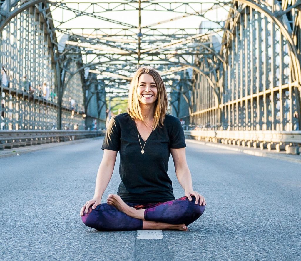 Thinkific course creator, Lizzie Lasater doing yoga pose on a bridge Thinkific course creator, Lizzie Lasater doing yoga pose on a bridge