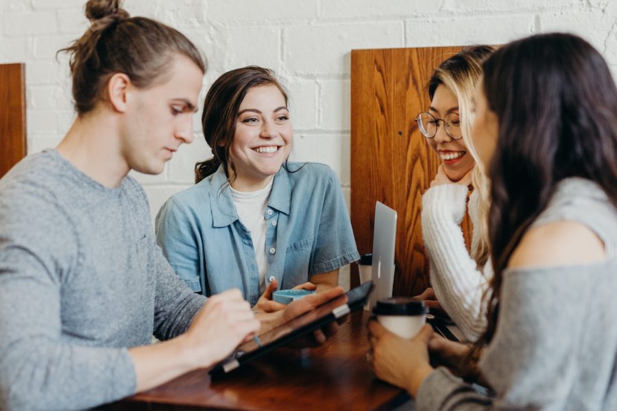 Group members enjoying eachother's company in a coffee shop