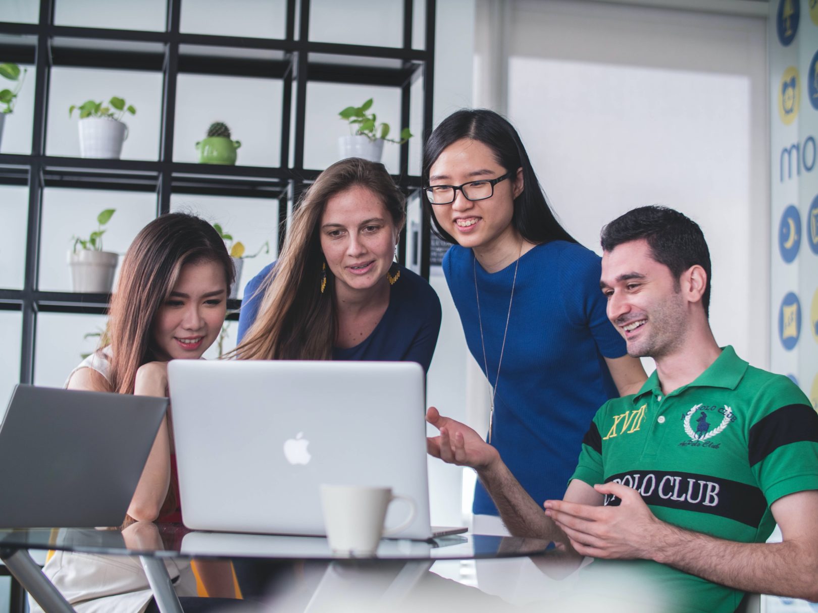 Group of people looking at a laptop to signify the power of affiliate marketing for your online course