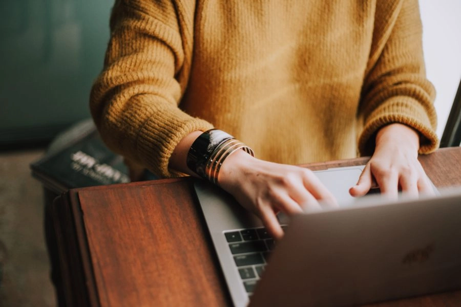 Image of person typing on computer