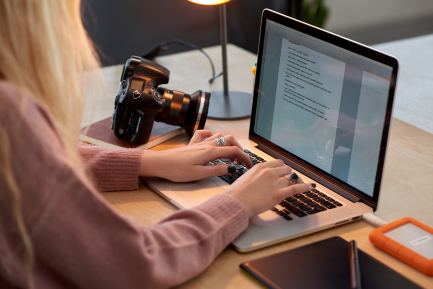 Female Photographer writing a blog