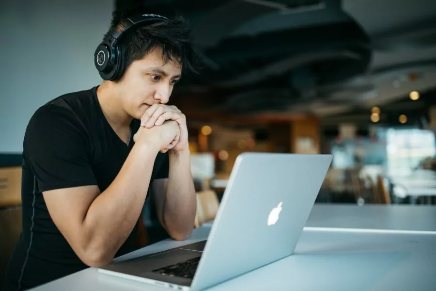 Man looking at computer trying to price coaching services