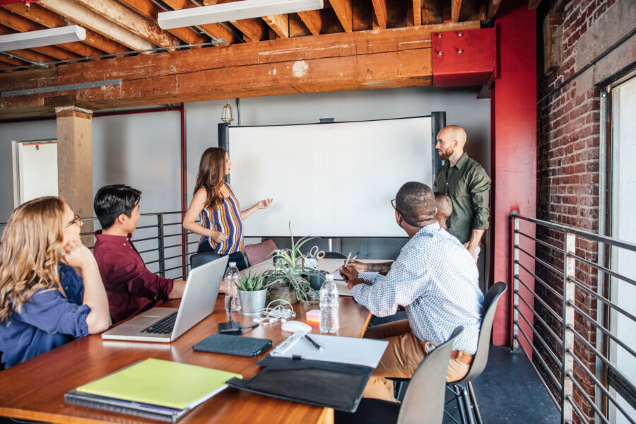 Group meeting in front of a whiteboard