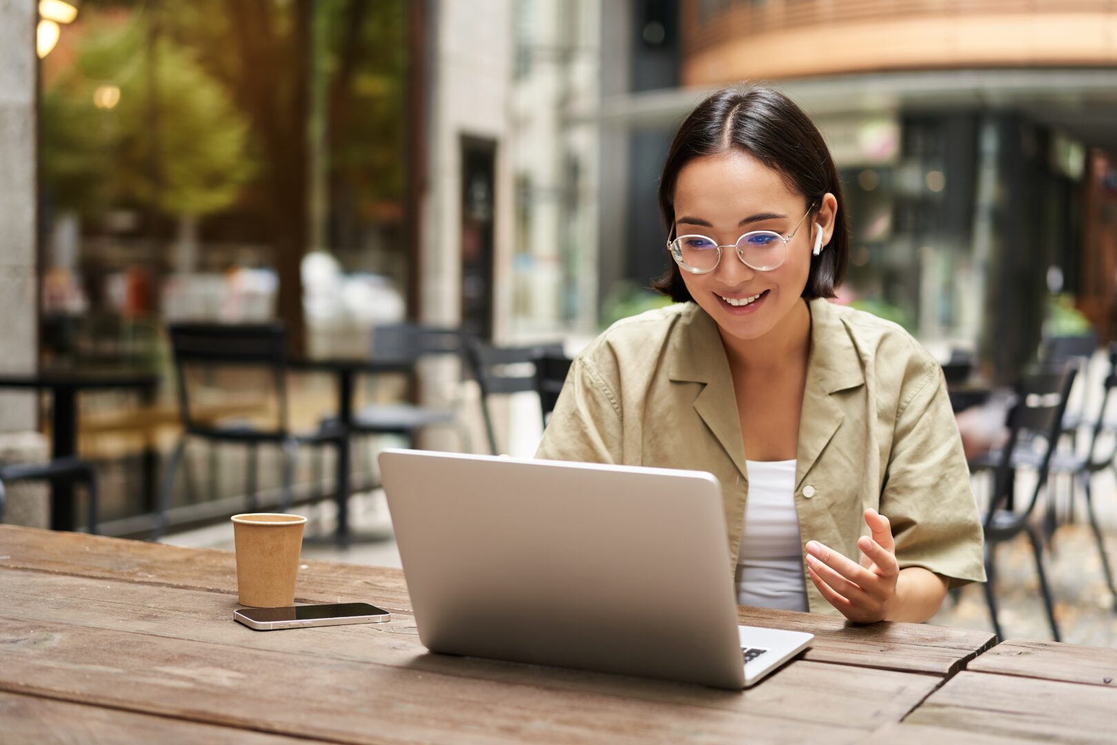 woman sitting at computer looking excited