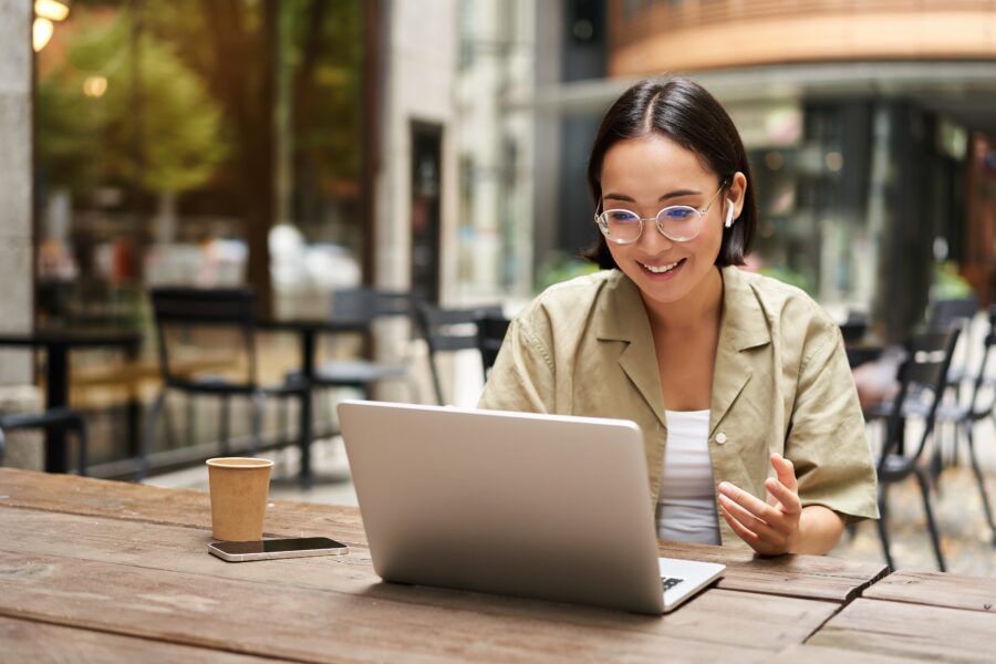 woman sitting at computer looking excited