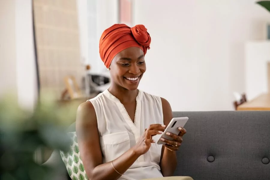 young woman selling digital products on her phone