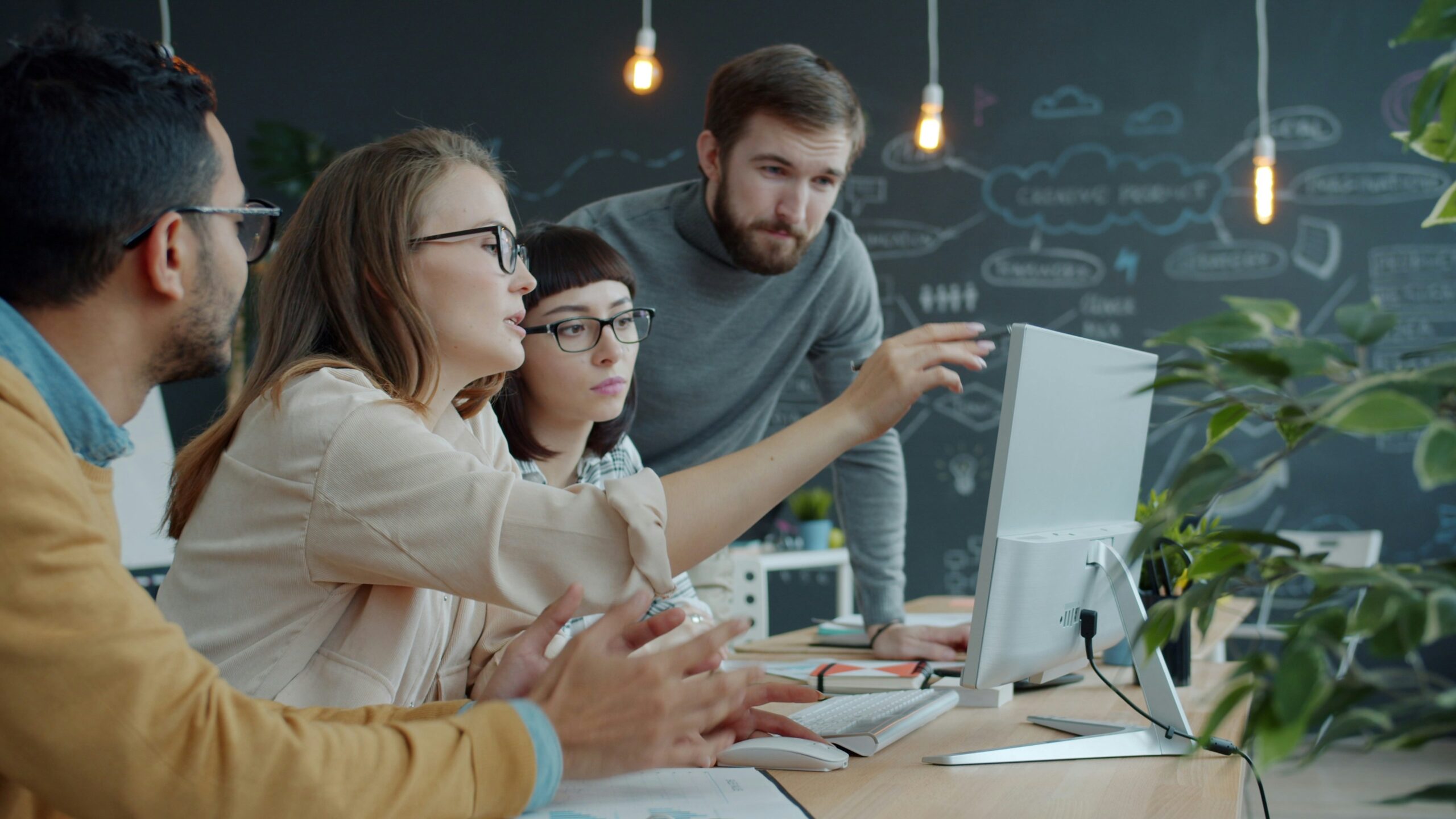 Team looks at a computer together